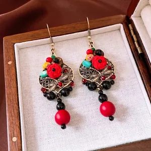 Vintage Chinese style dragonfly earrings with red resin beads and golden metallic hooks