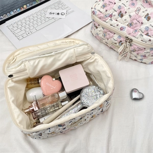 Detailed view of quilted cotton cosmetic bag with cute cartoon bear and rabbit prints