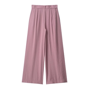 Detail of high-waisted wide-leg trousers in dusty pink with textured woven fabric
