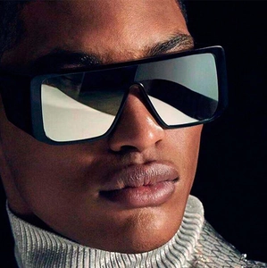 Close-up of oversized rectangular sunglasses with black frame and silver mirrored lenses