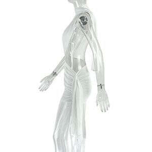 Detail of white halter dress featuring side ruched drawstring and cutout design