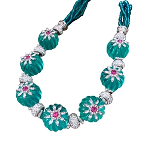 Collier vintage avec pendentif fleur, pierre verte et détails diamants sur chaîne perlée