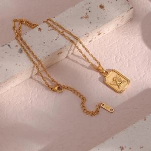 Gold angel rectangle pendant necklace with zircon border on textured stone base