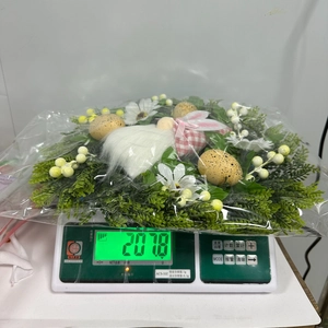 Detailed view of Easter wreath with gnome and eggs on scale showing 201.8g weight