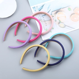 Detail of six pastel candy-colored cat ear headbands with soft polyester fabric texture