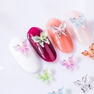 3D resin butterfly nail charms in colorful translucent designs on manicured nails