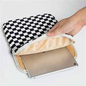 Detail of soft thickened fleece lining inside the black and white checkered laptop sleeve