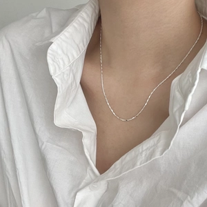 Minimalist 925 sterling silver cube necklace on model's neck for a delicate look