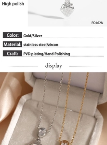 Macro detail of strawberry pendant necklace in gold and silver finish with zircon
