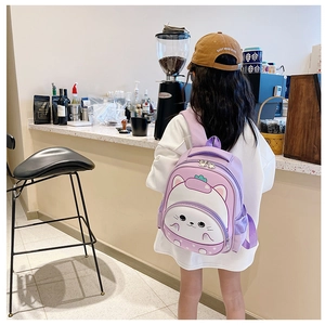 Rear view of child wearing purple cartoon cat backpack showing size and fit in use