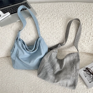 Detail of soft tie-dye canvas hobo bags with wide straps for campus life and daily commute
