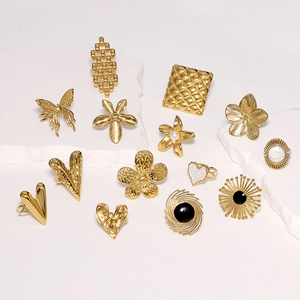 Collection of gold stainless steel rings with flower, heart and butterfly shapes