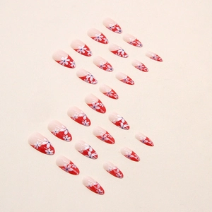 Faux ongles amande French rouges avec jolis motifs floraux blancs sur fond beige
