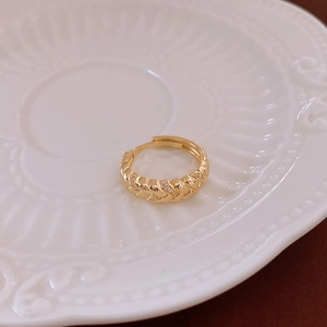 Detail of vintage gold twisted rope ring featuring sparkling cubic zirconia stones