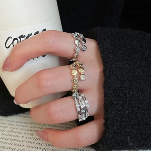 Close-up of triple-layered pearl and zircon rings worn on hand for a chic lifestyle look