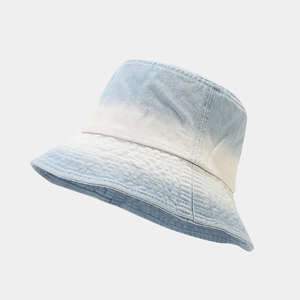Detailed view of the gradient tie-dye denim bucket hat with premium washed texture