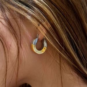 Modern 18k gold plated two-tone C-hoop earrings shown on a model for a stylish look