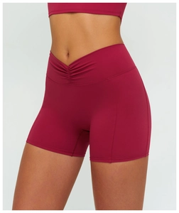 Close-up of deep red sports shorts featuring a V-shaped high waist and ruched booty detail