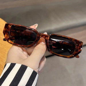 Close-up of stylish tortoise shell rectangle sunglasses with dark lenses and wide temples