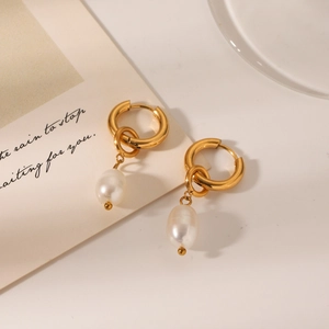 Gold hoop earrings with natural white baroque pearls in a minimalist elegant design