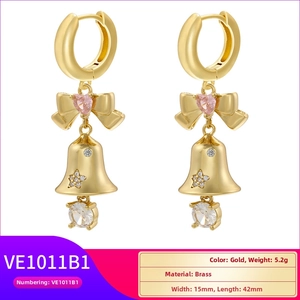 Detailed view of gold bell earrings with pink heart gems and star accents measuring 15mm by 42mm