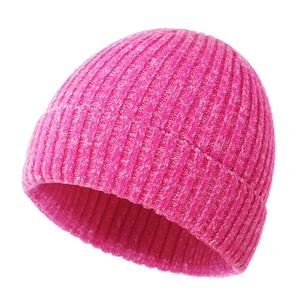 Close-up of rose pink ribbed knit baby beanie with folded brim and warm texture