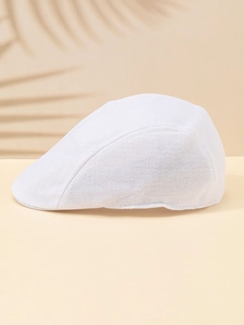 Close-up of white breathable mesh texture on a summer flat cap with elegant leaf shadows