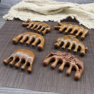 Handcrafted sandalwood meridian massage combs in various animal and floral shapes