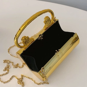 Golden lion head evening clutch bag with metal chain strap and black velvet interior
