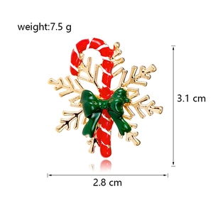 Enamel Christmas candy cane brooch with green bow on gold snowflake base