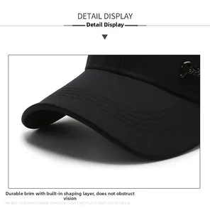 Detailed macro view of the reinforced brim and metal fashion decor on the black baseball cap