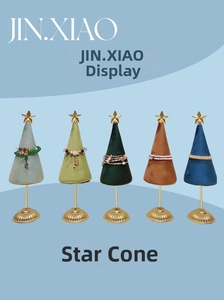 Detail view of five star-shaped cone jewelry display stands in assorted velvet colors