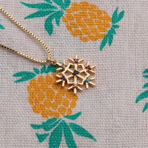 Gold plated snowflake necklace with multicolored zircons on a delicate chain