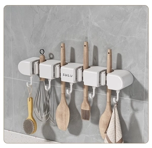Detail of wall-mounted suction kitchen organizer showing anti-slip hooks and slots