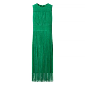 Close-up of emerald green knitted maxi dress featuring dense long fringe tassels