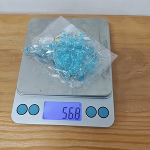 Detailed close-up of 5-piece light blue acrylic snowflake ornaments weighing 56.8 grams