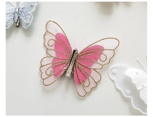 Detail view of pink mesh butterfly clip with gold sequins and durable metal duckbill back