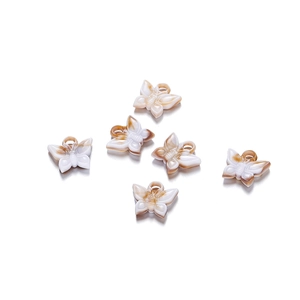 Detailed view of six amber-textured acrylic butterfly charms for DIY jewelry making