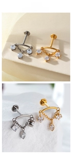 Macro detail of F136 titanium labret studs with zirconia chains in silver and gold finish