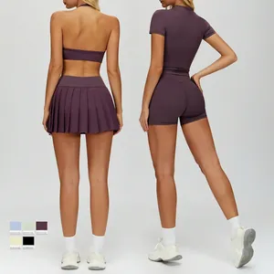 Women's deep purple high-stretch yoga set featuring racerback top and pleated tennis skirt
