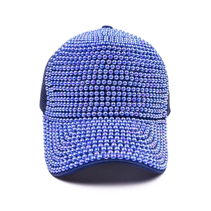 Navy blue baseball cap with iridescent pearl and rhinestone embellishments on white background