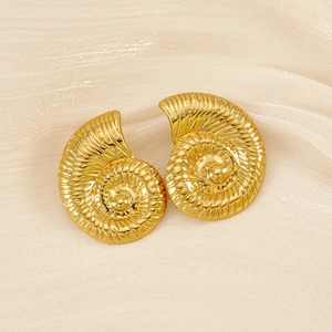 Detail shot of vintage 18K gold plated shell earrings on white silk fabric texture