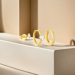 Three-piece gold S925 silver earring set with white zircons on minimalist steps