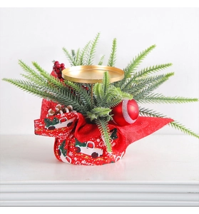 Close-up of a Christmas candle holder with pine needles, red berries and a festive base