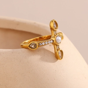 Detail of 18K gold-plated cross ring with white pearls and sparkling rhinestones