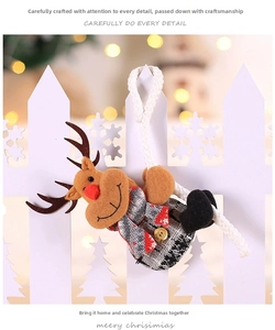Close-up of reindeer plush ornament with red nose and plaid scarf on white fence