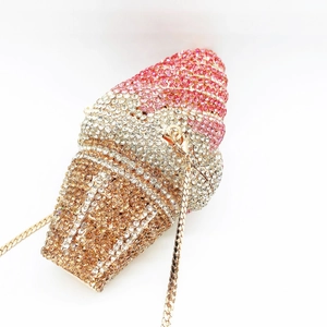 Macro view of crystal encrusted ice cream cone clutch with sparkling pink and gold rhinestones