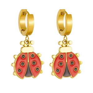 Detail of ladybug earrings featuring red enamel wings and polished gold plated metal hoops