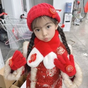 Close-up of red and white knitted scarf and hat set with traditional Fu character