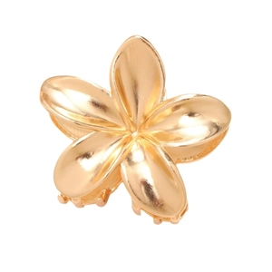 Polished gold frangipani flower hair claw clip with metallic finish on white background